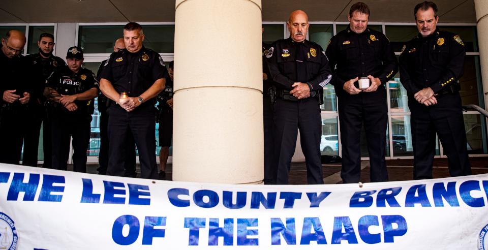 Members of local law enforcement agencies including the Fort Myers Police Department, The Cape Coral Police Department and others take part in a candlelight vigil at the Federal Courthouse in downtown Fort Myers on Wednesday, Jan. 26, 2022. The local chapter of the NAACP held the vigil to honor officers that have died in the line of duty and to promote unity among law enforcement and the community. They held the event in light of the recent police shootings in New York.