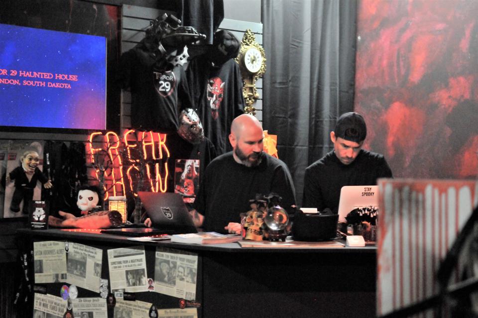 Owner Zac Tenneboe assists part-owner Trevor Nash-Keller on May 10, 2024, at the new Mystery Shop of Horrors & Curiosities in Brandon, SD.