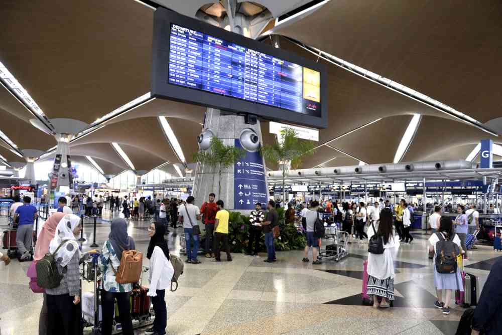 Travellers queue up to check-in for their flights at the Kuala Lumpur International Airport in Sepang August 24, 2019. ― Pictures by Miera Zulyana