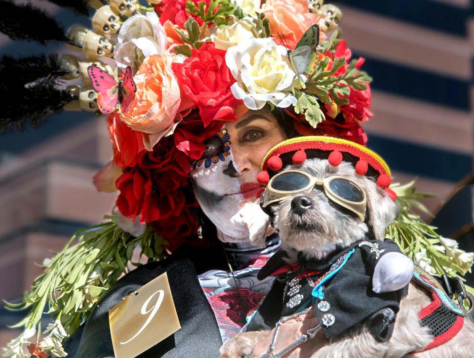Kathy Franco and her dog Kirby compete in the Catrina Pageant at the Dia De Los Muertos Street Fiesta in downtown Stockton on Oct. 26, 2019.