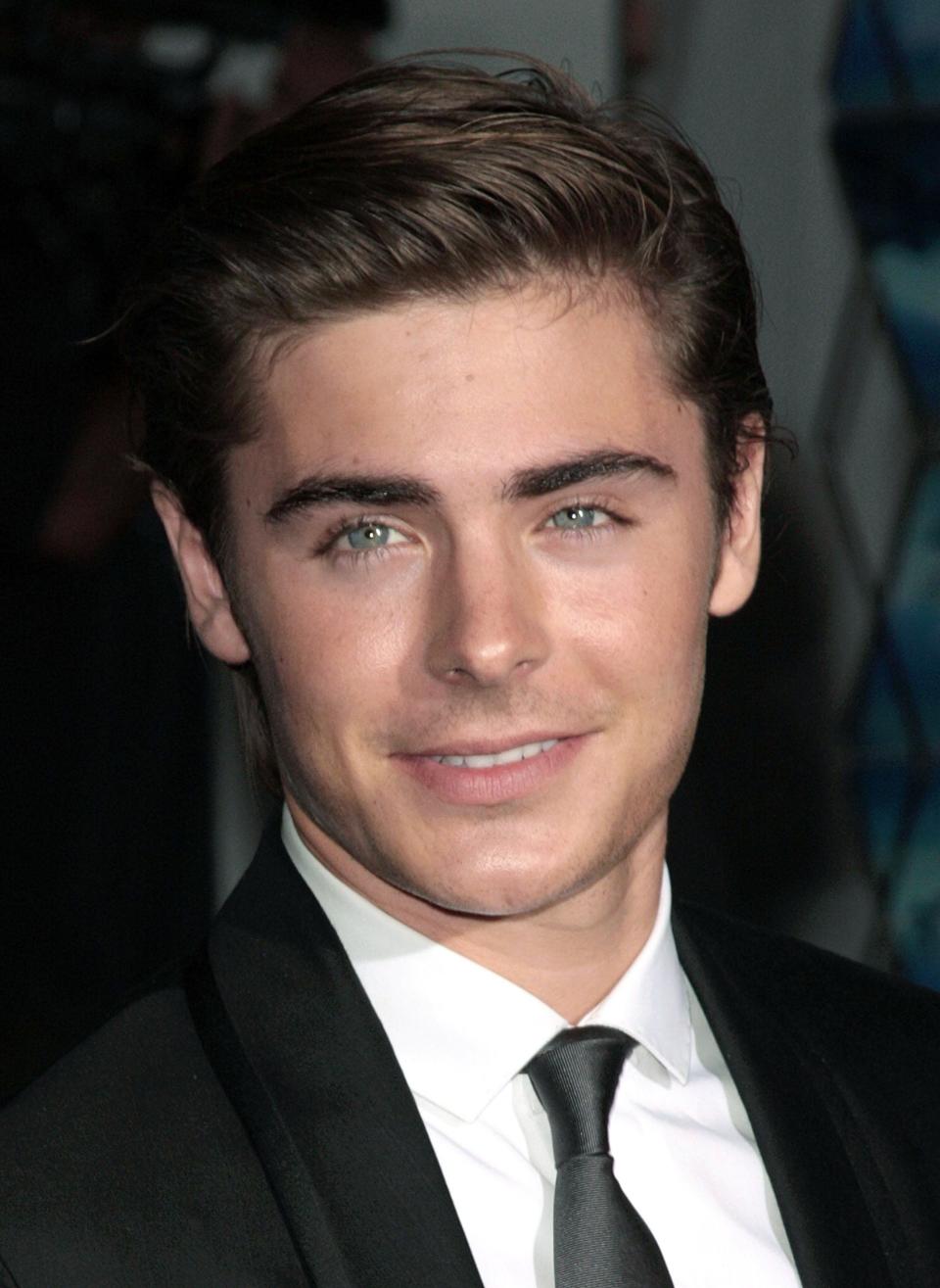 A closeup of Zac Efron smiling