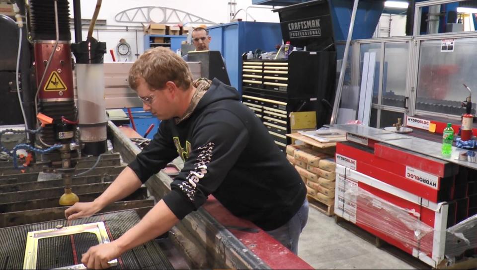 Boeing employee works to create PPE face shield for healthcare workers fighting COVID-19.