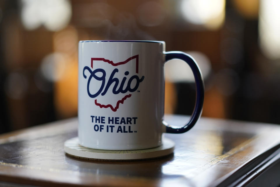 Ohio Gov. Mike DeWine's coffee mug reads "Ohio the heart of it all" as it sits next to his chair before an interview with The Associated Press at the Ohio Governor's Residence in Columbus, Ohio, Thursday, Dec. 21, 2023. (AP Photo/Carolyn Kaster)