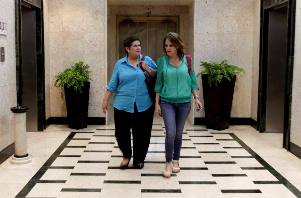 Fabiola Brana, left and her daughter Astrid Brana walk through Hotel Cohiba where they are staying in Havana, Cuba, Wednesday March 28, 2012. The two are part of a delegation of more than 300 mostly Cuban-American pilgrims visiting the island in honor of Pope Benedict XVI’s visit. Fabiola Brana was born in Cuba and left when she was 16-years-old. Both live in Miami. (AP Photo/Franklin Reyes)