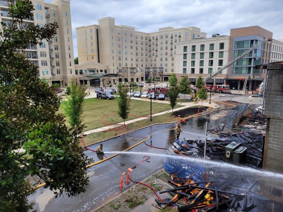 Firefighters continues to work the scene of a fire in Charlotte’s South Park neighborhood Thursday morning.