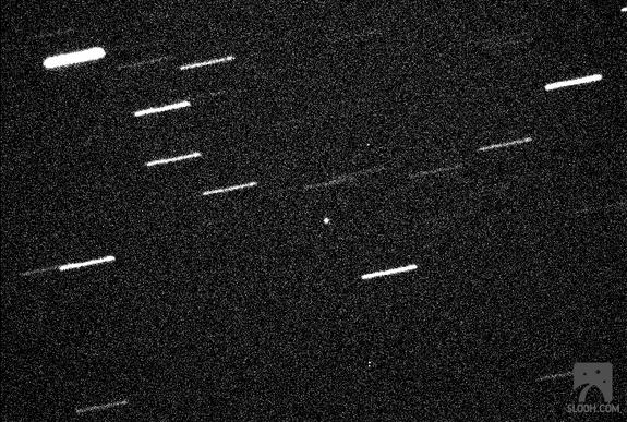 The 460-foot (140-meter) asteroid 2013 ET is seen through a Slooh Space Camera telescope in the Canary Islands on March 9, 2013, during its close approach to Earth. The asteroid was just within 600,000 miles of Earth, about 2.5 times the Earth