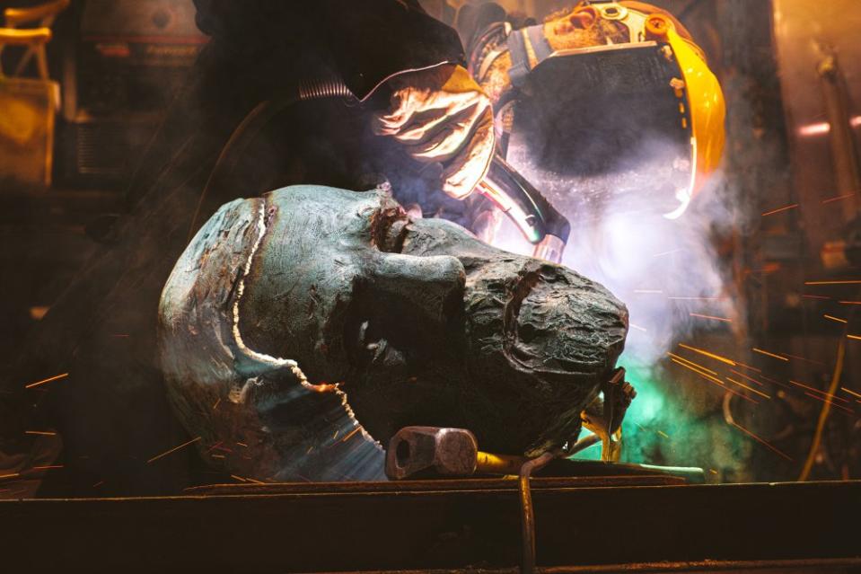 A worker using a plasma torch cuts the head of a bronze monument to Civil War General Robert E. Lee that formerly stood in Charlottesville, Va. before it is melted at a foundry on Oct. 21. As part of the "Swords Into Plowshares" project, the statue was melted down with the intention to use the metal to make a new public artwork.<span class="copyright">Eze Amos—Getty Images</span>