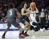 Alabama guard Jahvon Quinerly (5) drives to the basket against Oklahoma guards Milos Uzan (12) and Otega Oweh (3) during the first half of an NCAA college basketball game Saturday, Jan. 28, 2023, in Norman, Okla. (AP Photo/Garett Fisbeck)