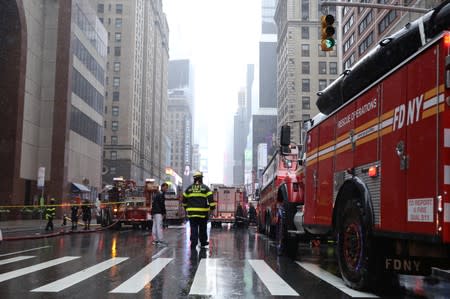 New York City Fire Department trucks and firefighters outside 787 7th Avenue in midtown Manhattan where helicopter crashed in New York