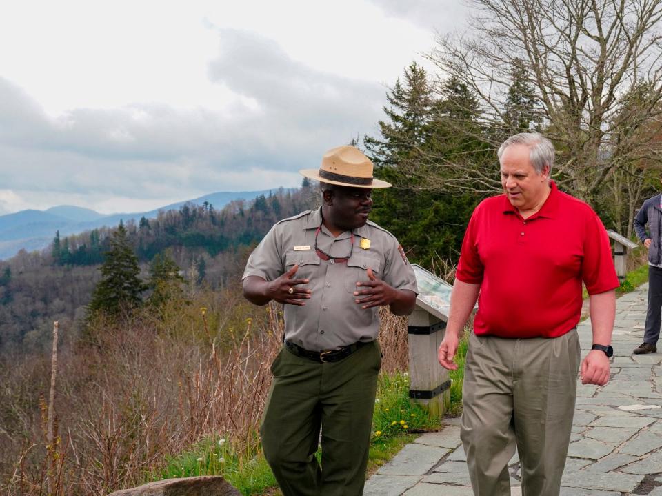 This Wednesday, May 6, 2020 image from a tweet by Interior Secretary David Bernhardt, the Interior Secretary talks with Cassius Cash, the park superintendent, as he visits National Parks Service employees at Great Smoky Mountains National Park.