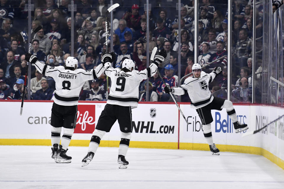 Los Angeles Kings' Pierre-Luc Dubois (80) celebrates his goal against the Winnipeg Jets with Drew Doughty (8) and Adrian Kempe (9) during the second period of an NHL hockey game, Tuesday, Oct. 17, 2023 in Winnipeg, Manitoba. (Fred Greenslade/The Canadian Press via AP)