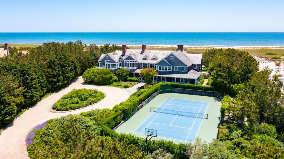 At the front of the Hamptons mansion is a north-south tennis court - Credit: Compass