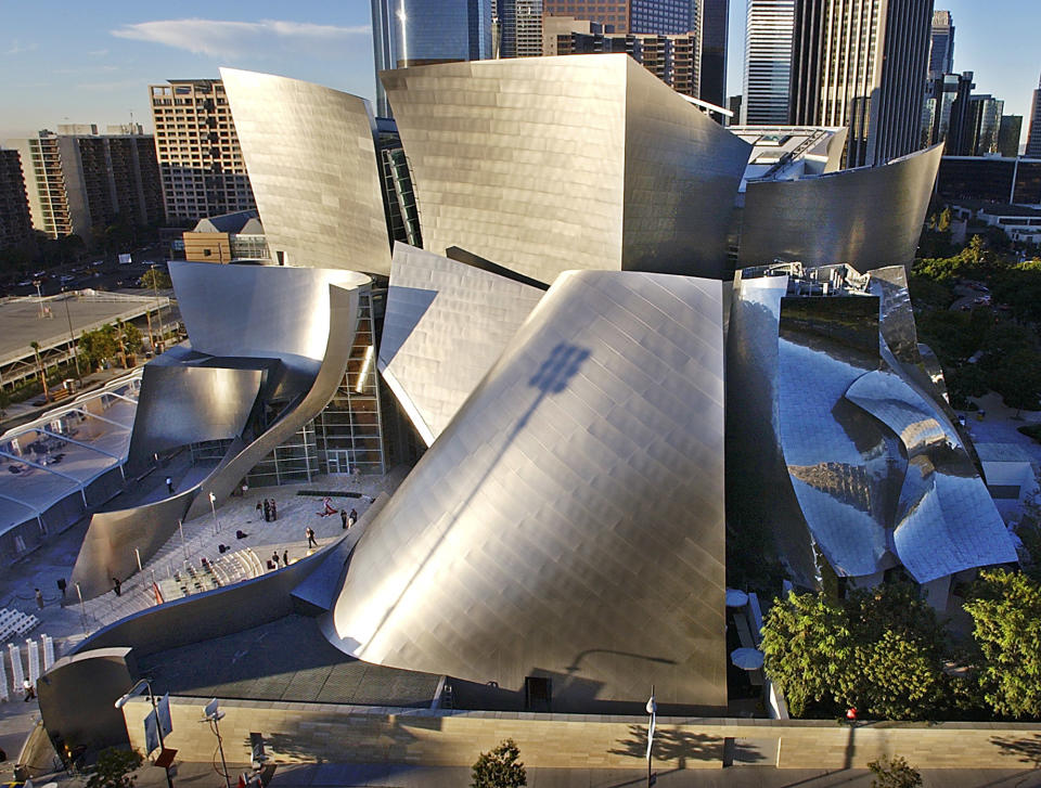 This Oct. 20, 2003 file photo shows early morning sun illuminating the new Walt Disney Concert Hall in downtown Los Angeles. Downtown has undergone a revival in recent years, adding upscale condos, chichi bars and the iconic, Frank Gehry-designed Walt Disney Concert Hall. (AP Photo/Nick Ut, file)