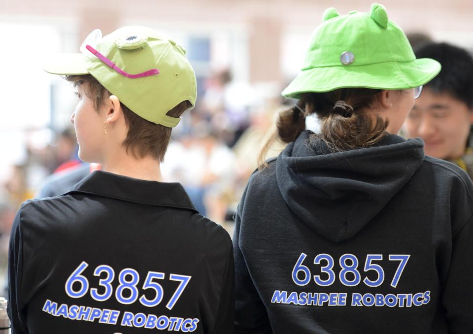 Seniors Jamie Hughes, left, and Katrinia Mayen keep an eye on the robotics competition ring ahead of their match on Saturday at Mashpee Middle-High School.