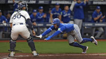Toronto Blue Jays' George Springer scores ahead of the throw to Tampa Bay Rays catcher Rene Pinto (50) on a two-run double by Bo Bichette during the seventh inning of a baseball game Thursday, March 28, 2024, in St. Petersburg, Fla. (AP Photo/Chris O'Meara)