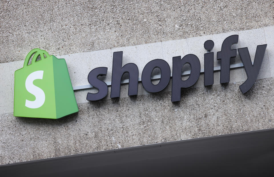BERLIN, GERMANY - AUGUST 08: The corporate logo of e-commerce company Shopify hangs at the building that contains the offices of Shopify Commerce Germany GmbH on August 08, 2022 in Berlin, Germany. Shopify is a leading, Canada-based company that enables online and brick-and-mortar commerce. (Photo by Sean Gallup/Getty Images)