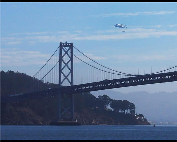 Endeavour soars over Treasure Island and the Bay Bridge. Courtesy @sheigh.