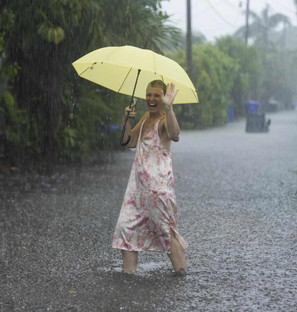 Laura Collinhofer holds an umbrella after moving her cars to higher ground as heavy rain falls over parts of South Florida on Wednesday, June 12, 2024, in Hollywood, Fla. (Matias J. Ocner/Miami Herald via AP)