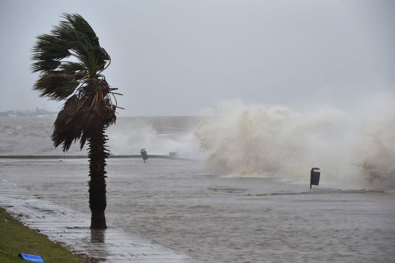 Waves crash over Montevideo's Rambla during the passage of a subtropical cyclone on May 17, 2022. (Photo by Pablo PORCIUNCULA / AFP)