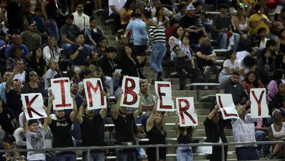 Spectators send a message to a graduate during the McLane High graduation at the school stadium on June 6, 2023.