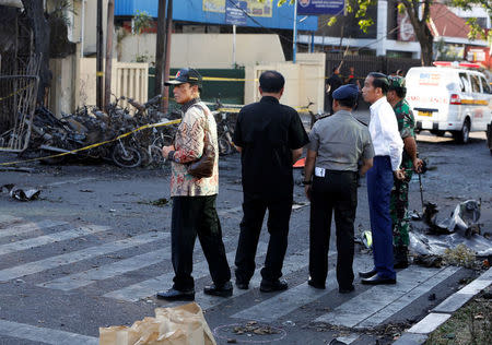 Indonesia President Joko Widodo (white shirt) visits the burned church location at the Pentecost Church Central Surabaya (GPPS), in Surabaya, Indonesia May 13, 2018. REUTERS/Beawiharta