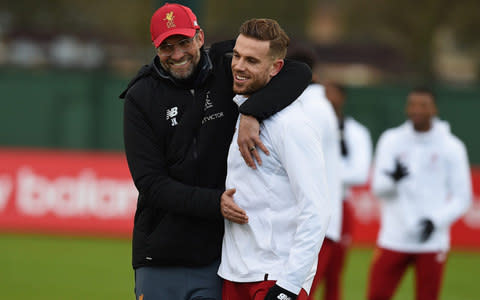 Jurgen Klopp hugs Jordan Henderson - Credit: GETTY IMAGES