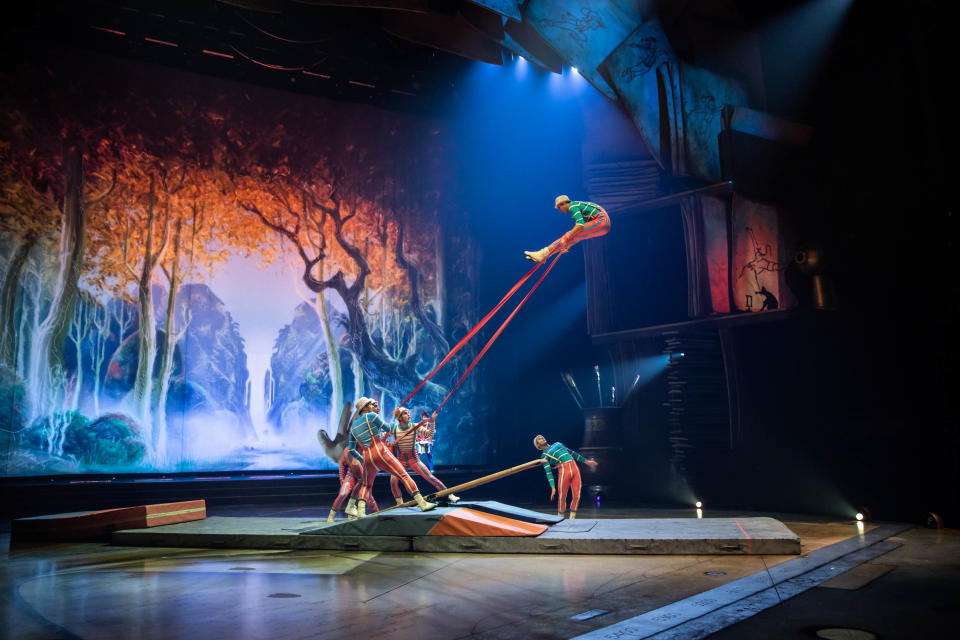 Gymnasts attached to rubber bands spring from a teeterboard to pay tribute to Disney animators' love of a good rubber band fight. (Photo: Cirque du Soleil)