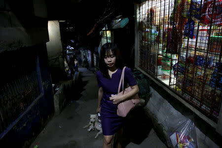 Janice Sarad, 22, who works for a bank, walks down a street to her home in Antipolo City, Rizal province, in Philippines, December 3, 2018. Sarad usually arrives home between 20:30 to 21:30. "My boss knows how far away my house is. When I get to work late, he just tells me to leave my home 30 minutes earlier to compensate. I really want to be transferred to a different location, somewhere closer to my home," she said. REUTERS/Eloisa Lopez