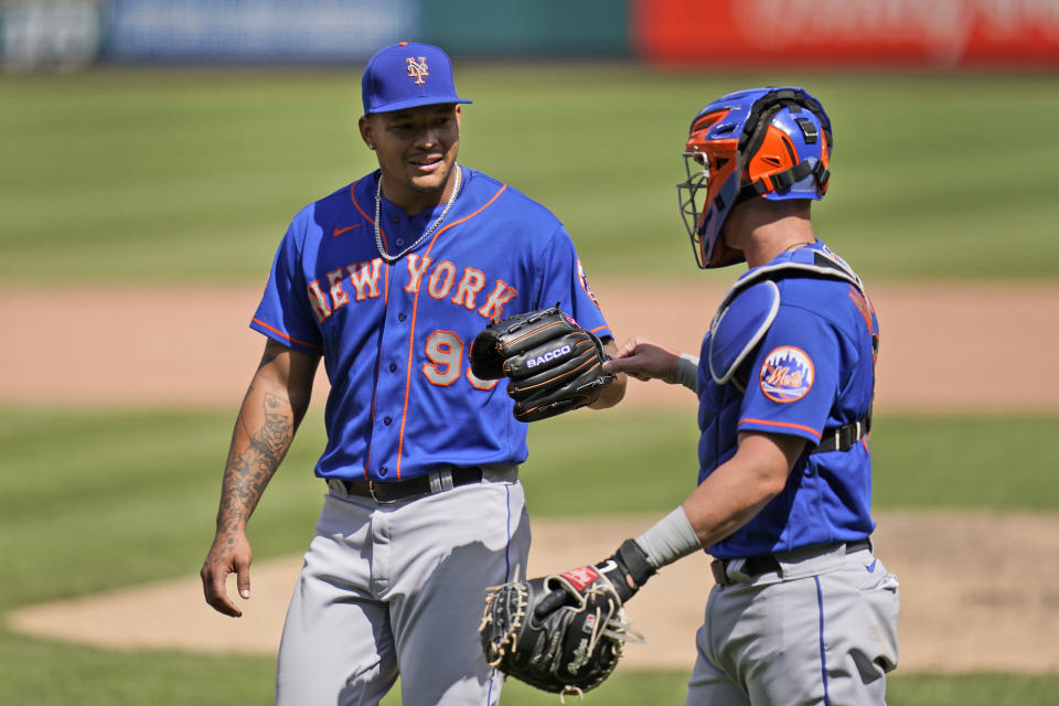 New York Mets starting pitcher Taijuan Walker, left, is congratulated by catcher James McCann as they head off the field after working the seventh inning of a baseball game against the St. Louis Cardinals Thursday, May 6, 2021, in St. Louis. (AP Photo/Jeff Roberson)