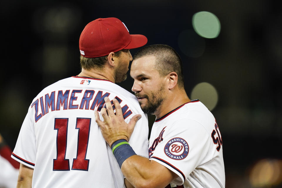 Washington Nationals' Ryan Zimmerman, left, and Kyle Schwarber react during the ninth inning of a baseball game against the New York Mets at Nationals Park, Monday, June 28, 2021, in Washington. (AP Photo/Alex Brandon)