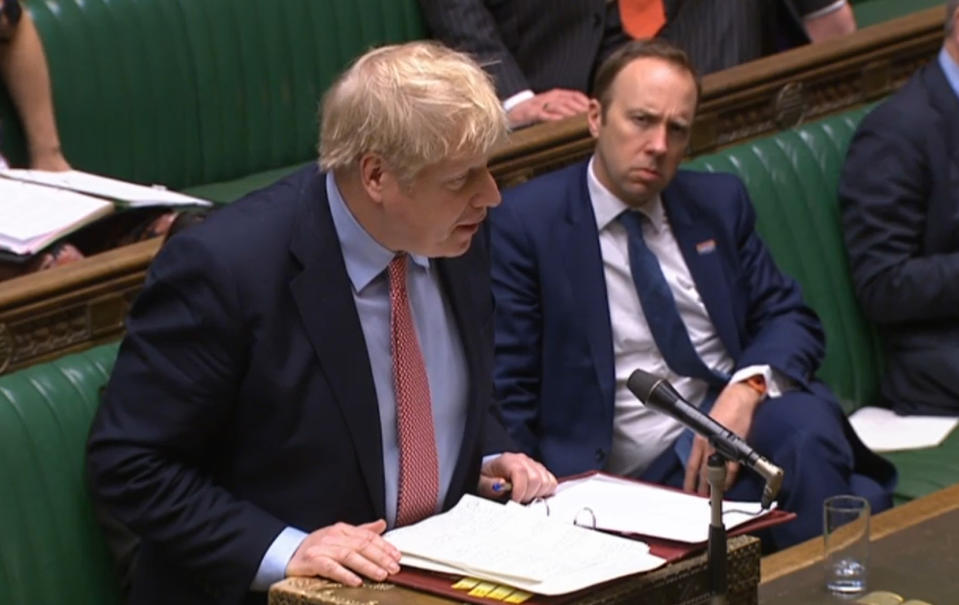 File photo dated 25/03/2020 of Health Secretary Matt Hancock watching Prime Minister Boris Johnson speak during Prime Minister's Questions in the House of Commons, London, both of them have tested positive for coronavirus.