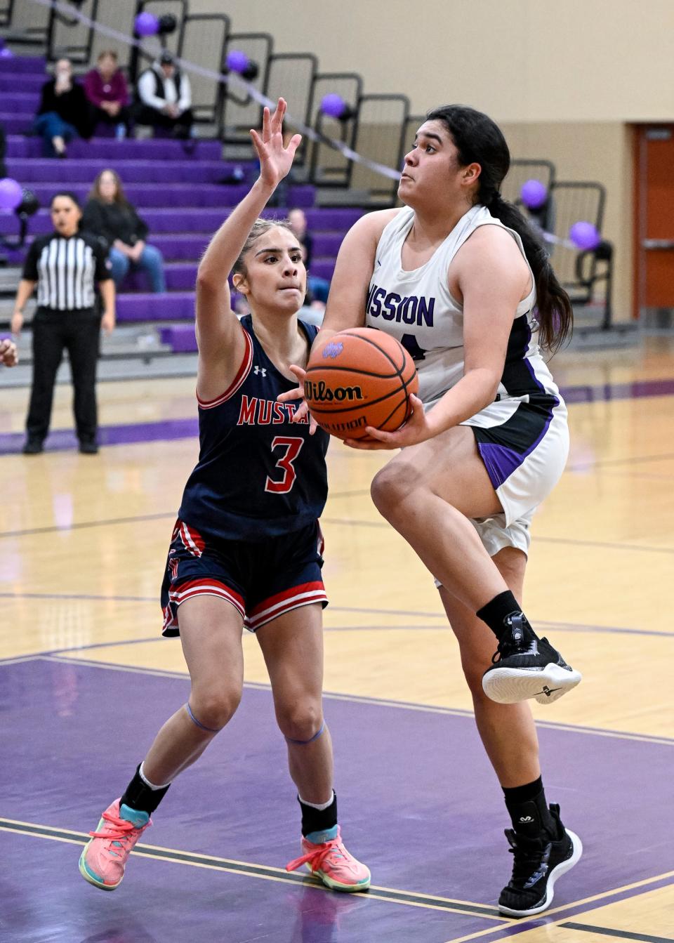 Mission Oak's Isabella Zepeda goes up for two against Tulare Western's Regina Toscano in a West Yosemite League high school girls basketball game Wednesday, January 10, 2024.