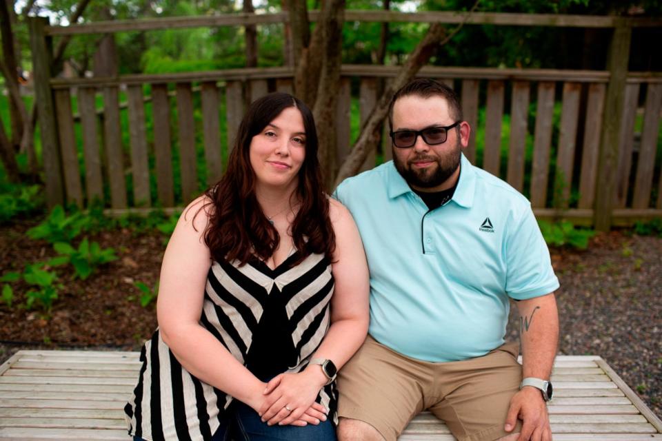 PHOTO: When Wasney (right) and his fiancée, Sarah Eberlein (left), bought their first home in Saginaw, Michigan, in 2018, their real estate agent gifted them tickets for a Royal Caribbean cruise. (Kristen Norman for KFF Health News)