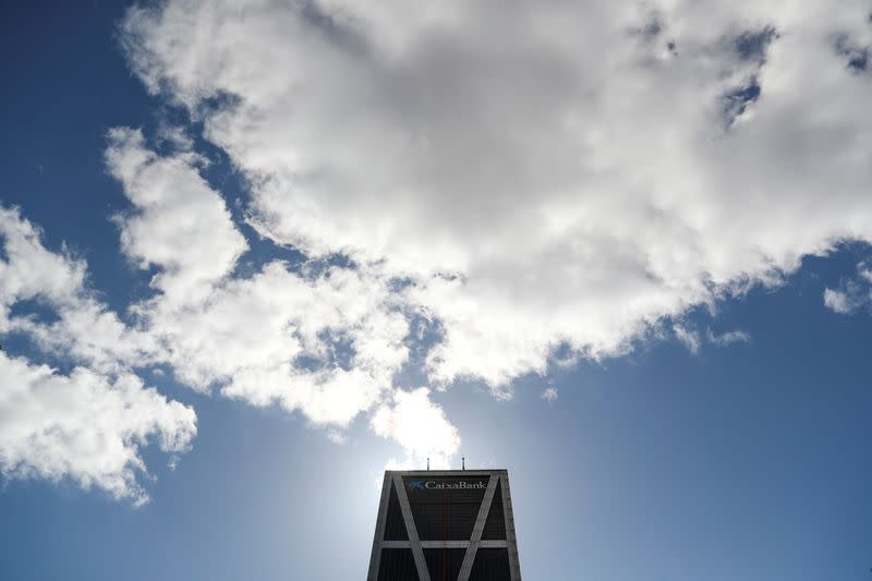 Clouds pass above CaixaBank headquarters in Madrid