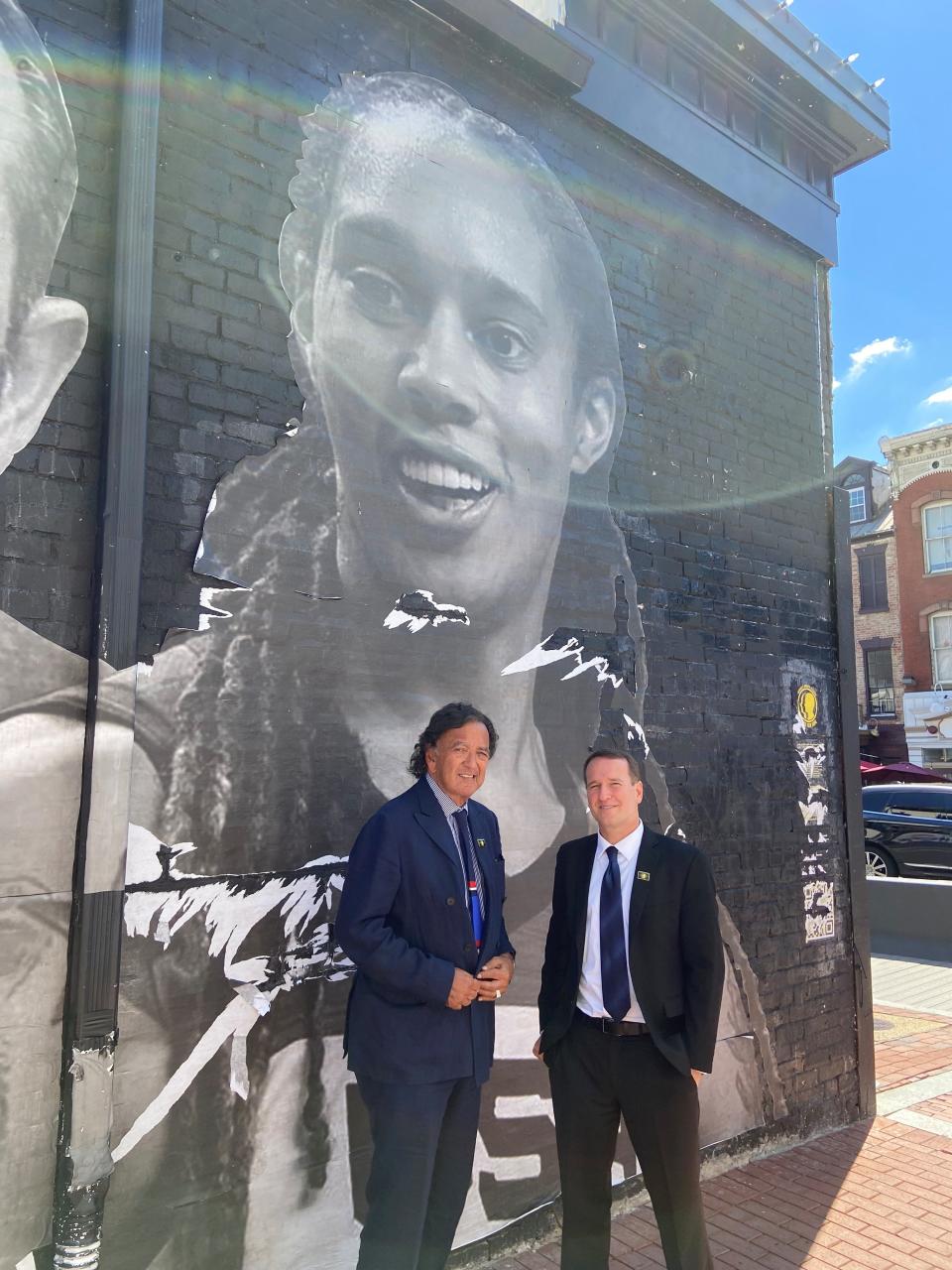 Mickey Bergman, right, and Bill Richardson, a former U.S. ambassador to the United Nations, in 2022 at a mural in Washington, D.C., depicting U.S. hostages detained abroad. Behind them is the image of Brittney Griner, the two-time Olympic gold medalist basketball player who was released from Russia that December in a prisoner exchange.