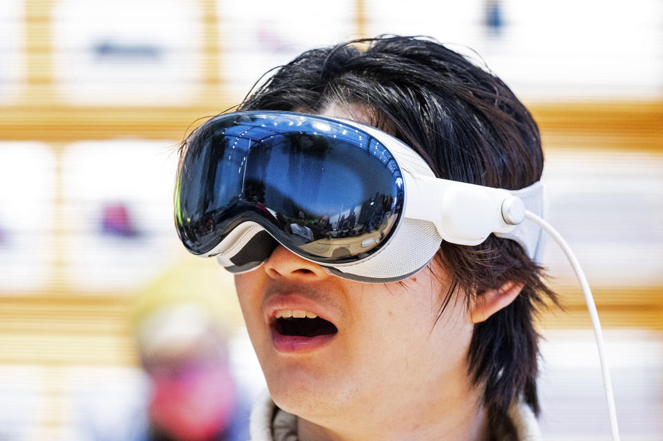 Bryan Chiang tries out the Apple Vision Pro headset during the first day of sales at the Apple store in Palo Alto, Calif., on Friday, February 2, 2024.  (AP Photo/Noah Berger)