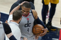 Washington Wizards head coach Scott Brooks talks with Russell Westbrook following an NBA basketball game against the Indiana Pacers, Saturday, May 8, 2021, in Indianapolis. Washington won 133-132 in overtime. (AP Photo/Darron Cummings)