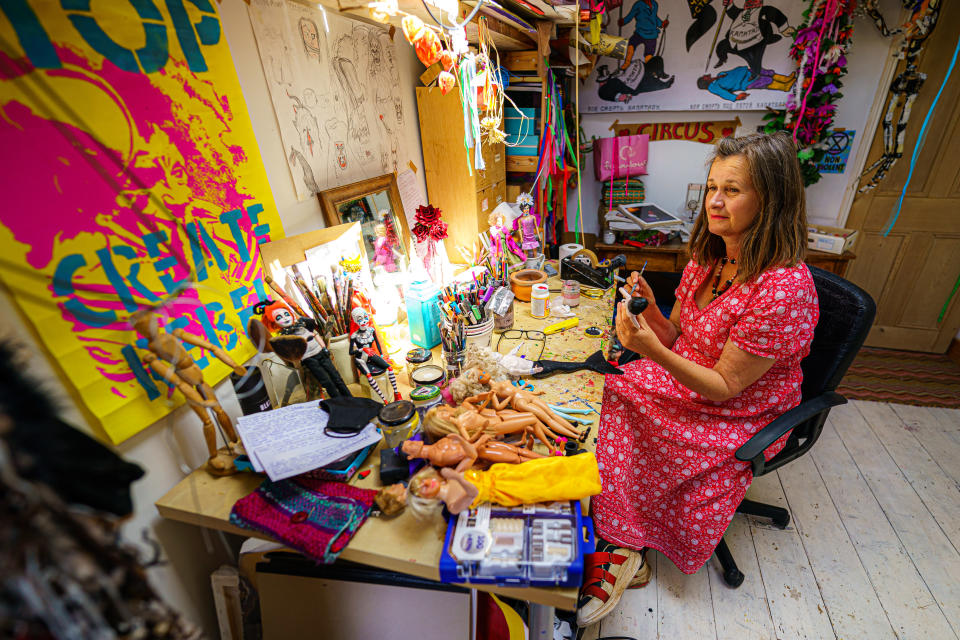Artist Lou Gray, 61, creates characters from old dolls including Barbie, Ken and Action Man, plus other assorted miniature doll figures, at her home studio in Bristol (Ben Birchall/PA Wire/PA Real Life)
