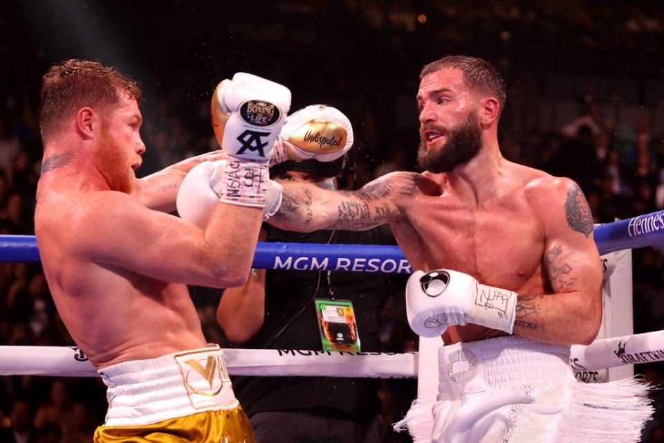 Caleb Plant (R) exchanges punches with Canelo Alvarez (Getty)