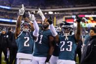 Philadelphia Eagles cornerback Darius Slay (2), defensive tackle Fletcher Cox (91) and safety C.J. Gardner-Johnson (23) gesture toward spectators during the second half of an NFL divisional round playoff football game against the New York Giants, Saturday, Jan. 21, 2023, in Philadelphia. (AP Photo/Matt Slocum)