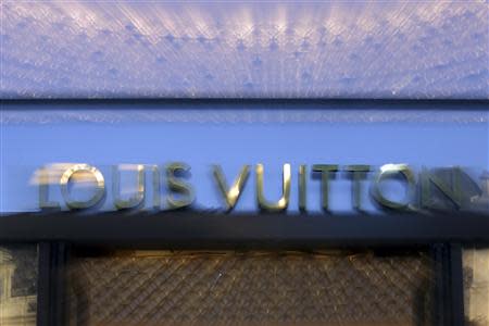 A Louis Vuitton sign is seen at one of their Paris stores September 24, 2013. REUTERS/Philippe Wojazer