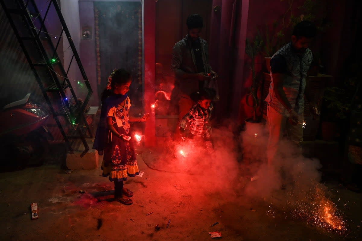 Children play with sparklers as they celebrate the Hindu festival Diwali or the Festival of Lights in New Delhi (AFP via Getty Images)