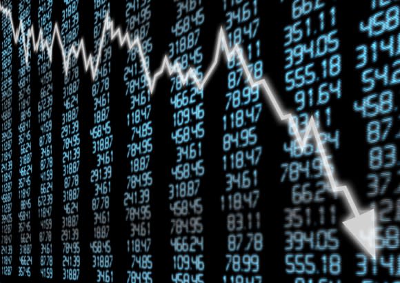 Stock market arrow graph falling over a blue display with numbers