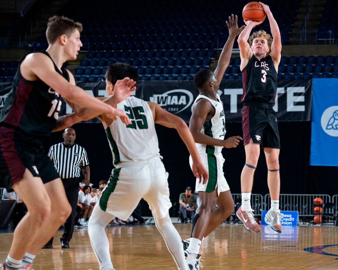 Mount Spokane guard Ryan Lafferty (3) makes a 3-pointer over Auburn guard Luvens Valcin (14) during the fourth quarter of the Class 3A 3rd/5th-place game on Saturday, March 4, 2023, in Tacoma, Wash.