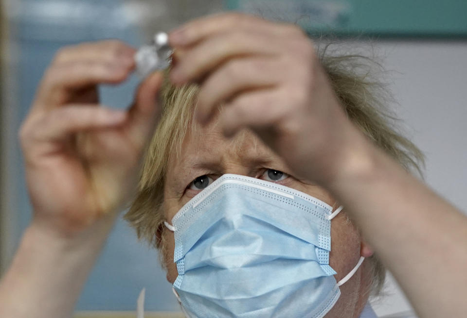 Prime Minister Boris Johnson holds a bottle of the Pfizer BioNTech vaccine during a visit to a coronavirus vaccination centre in Batley, West Yorkshire. Picture date: Monday February 1, 2021.