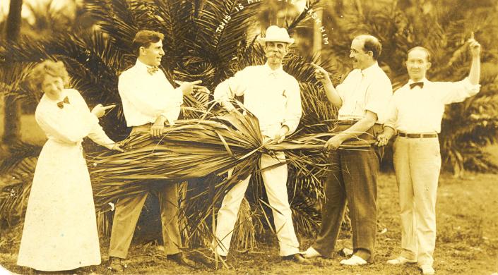 Ward G. Foster, center, is shown with men&#39;s haberdashery business leader Emile D. Anthony to his left. The other people in the photo are  unidentified.