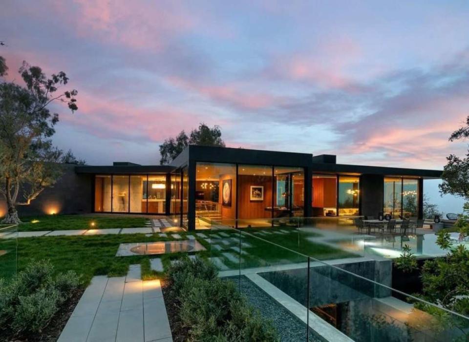 Exterior evening shot of film producer Ken Kao's sleek, glass-heavy Beverly Hills mansion.  