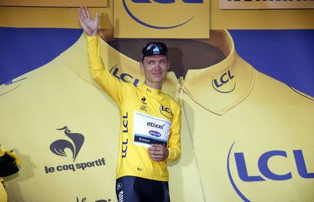 Etixx-Quick Step rider Tony Martin of Germany wears the race leader's yellow jersey on the podium after he crashed at the finish of the 191.5-km (118.9 miles) 6th stage of the 102nd Tour de France cycling race from Abbeville to Le Havre, France, July 9, 2015. REUTERS/Eric Gaillard