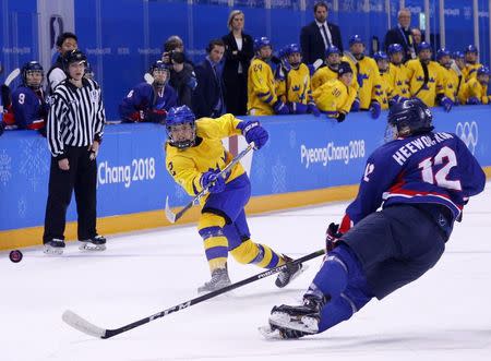Ice Hockey – Pyeongchang 2018 Winter Olympics – Women Preliminary Round Match - Sweden v Korea - Kwandong Hockey Centre, Gangneung, South Korea – February 12, 2018 - Emmy Alasalmi of Sweden in action with Kim Hee-won of Korea. REUTERS/Brian Snyder