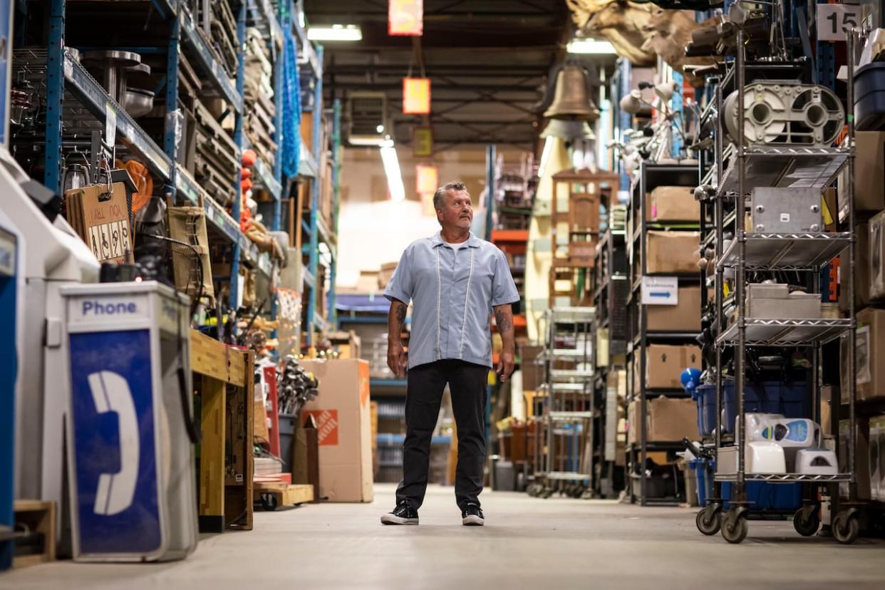 Jay Hauca is pictured at the Acme Prop Shop in Burnaby, B.C, on Sept. 7. He and his sister are now paying out-of-pocket to support staff amid a downturn in business due to strikes in the film industry south of the border. (Ben Nelms/CBC - image credit)